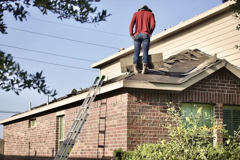 Professional roofer working on a residential roof in Wilshire Center